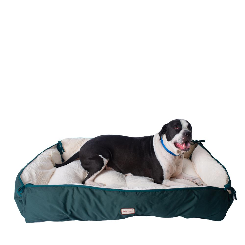 a green and white dog bed with pillows