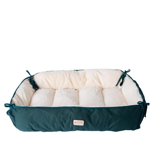 a green and white dog bed with pillows